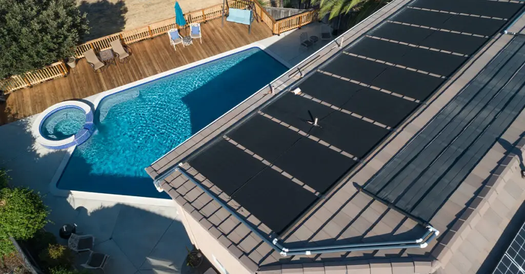 Solar pool heater on roof, connected to inground pool