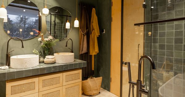 Beach themed bathroom with sand-colored tiles and green walls in modern style