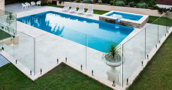 Glass fence around backyard swimming pool