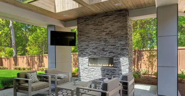 TV in outdoor kitchen with dining area