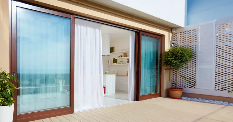 Tinted patio glass doors covered with curtains for privacy